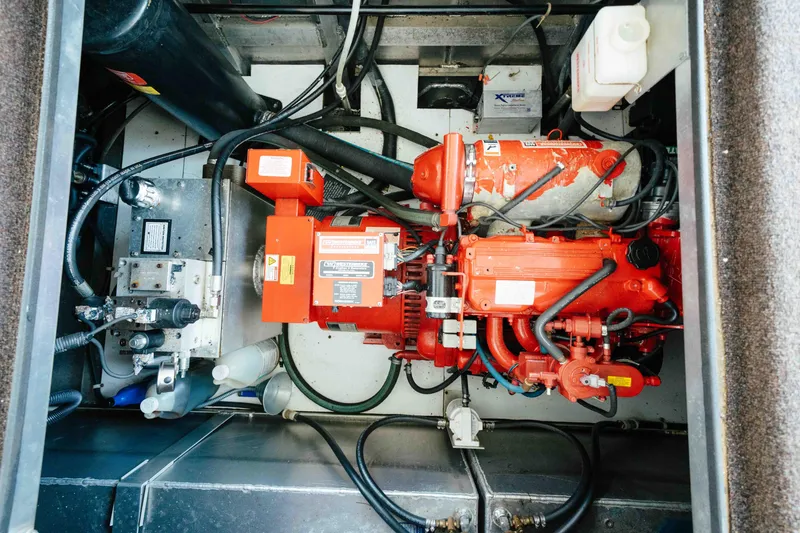 Slide: The Image of Engine compartment of a 2009 Horizon 18x85 boat, featuring red machinery and cables. - 62