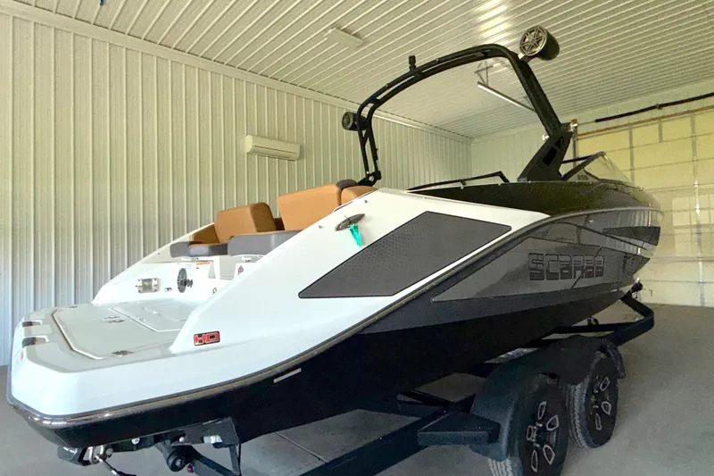 Slide: The Image of 2023 Scarab 255 ID boat in a garage, showcasing sleek design and modern features. - 11
