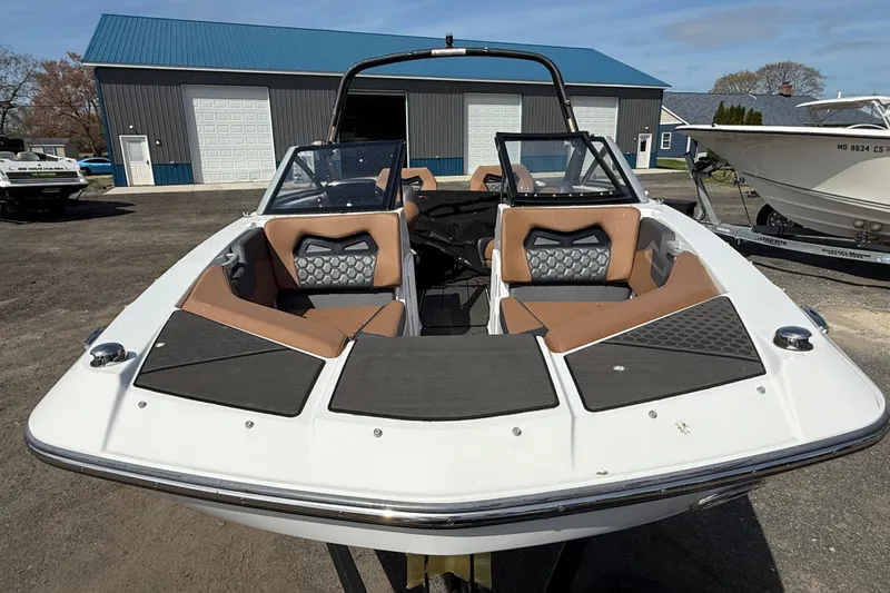 Slide: The Image of 2023 Scarab 255 ID boat with sleek design and modern seating, parked outdoors. - 14