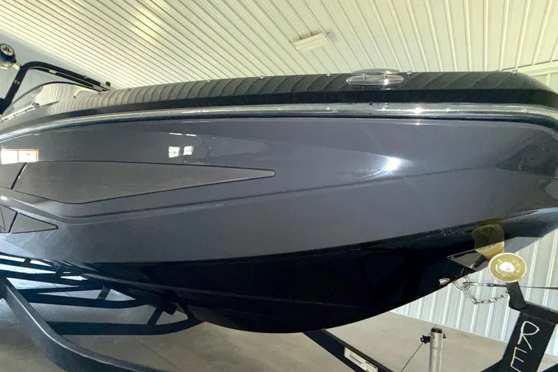 Slide: The Image of 2023 Scarab 255 ID boat in a showroom, showcasing sleek design and modern features. - 4