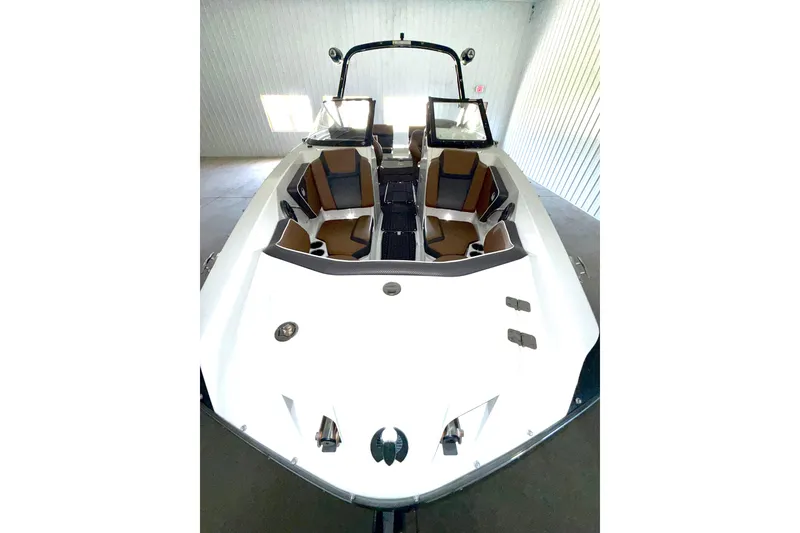 Slide: The Image of 2023 Scarab 255 ID boat interior with brown and black seating in a bright showroom. - 5