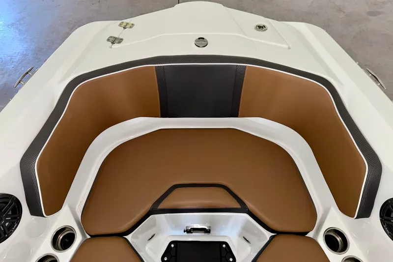 Slide: The Image of 2023 Scarab 255 ID boat interior with brown and black seating. - 7