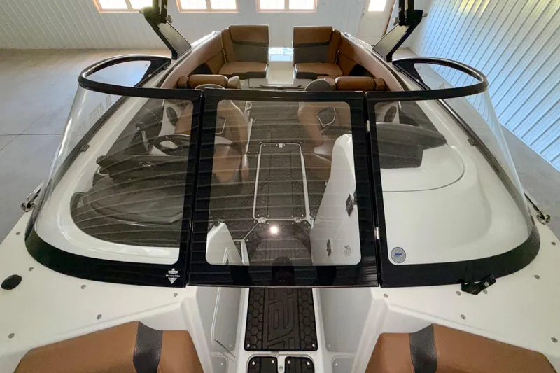 Slide: The Image of 2023 Scarab 255 ID boat interior with brown seating and sleek design. - 9
