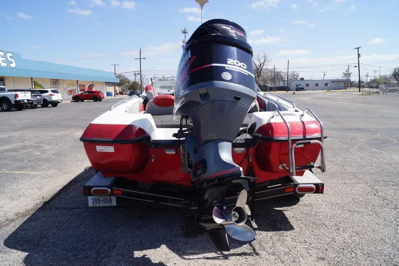 Slide: The Image of 2002 Skeeter SL 210 boat with Yamaha 200 outboard motor in a parking lot. - 11