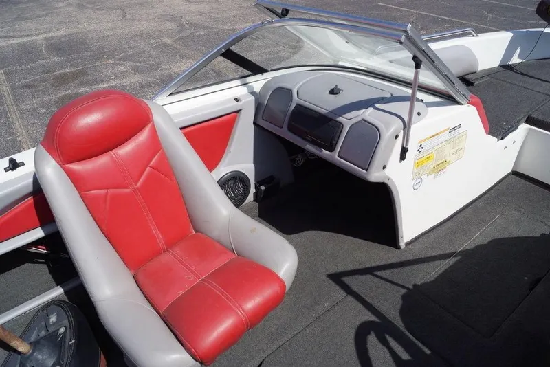 Slide: The Image of 2002 Skeeter SL 210 boat interior with red and gray seating and dashboard. - 13