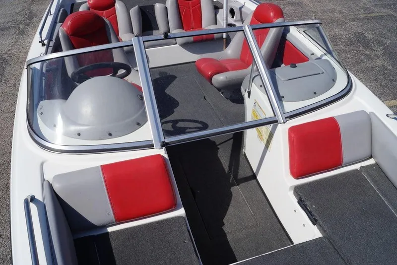 Slide: The Image of 2002 Skeeter SL 210 boat interior with red and gray seating, windshield, and steering wheel. - 14