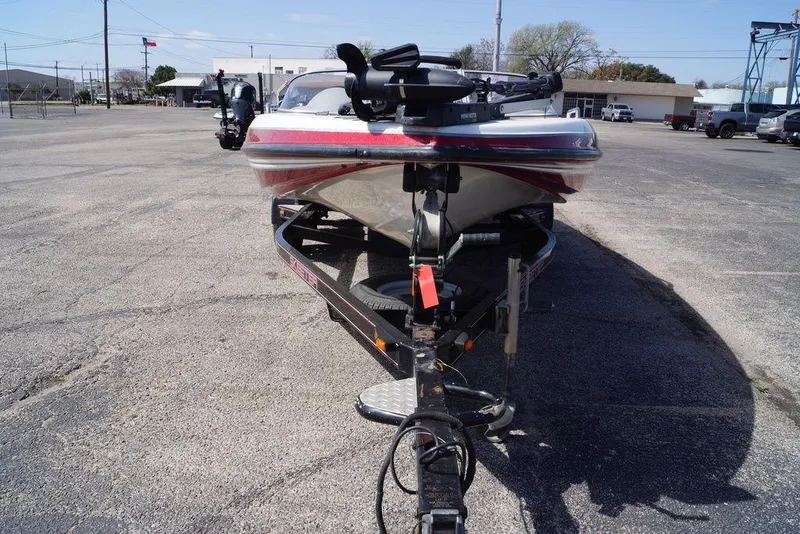 Slide: The Image of 2002 Skeeter SL 210 boat on trailer in parking lot, front view. - 2