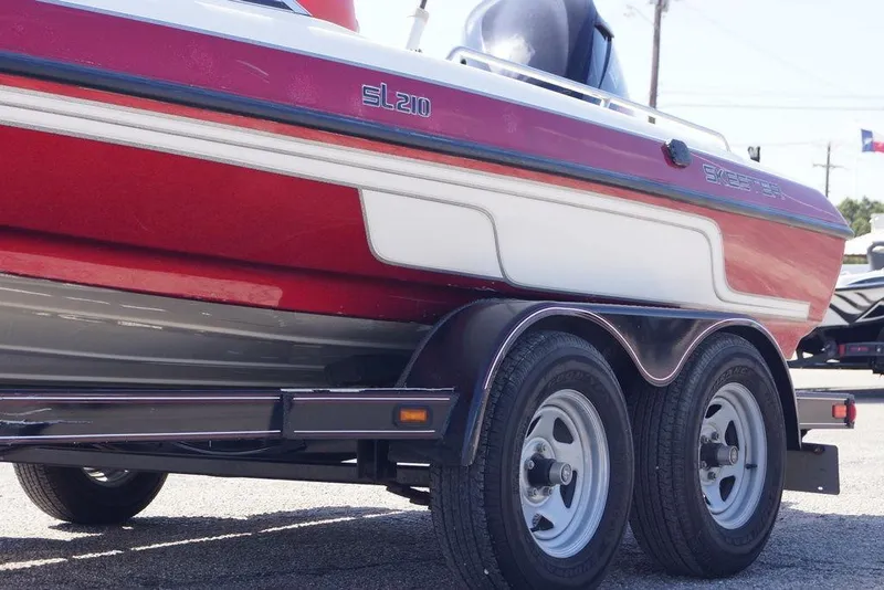 Slide: The Image of 2002 Skeeter SL 210 boat on trailer, red and white design. - 6