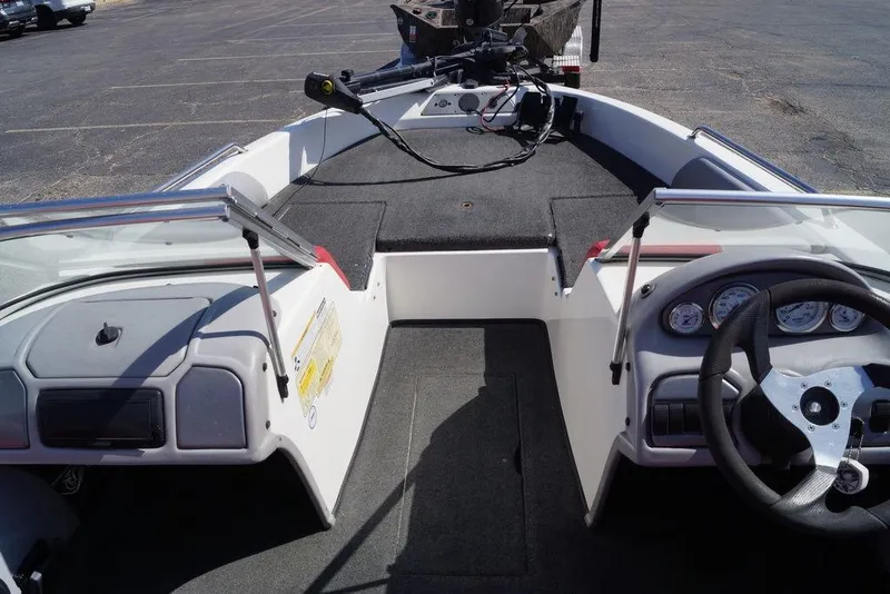 Slide: The Image of 2002 Skeeter SL 210 boat interior with steering wheel and dashboard controls. - 7