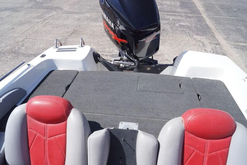 Slide: The Image of 2002 Skeeter SL 210 boat interior with red seats and Yamaha outboard motor. - 8