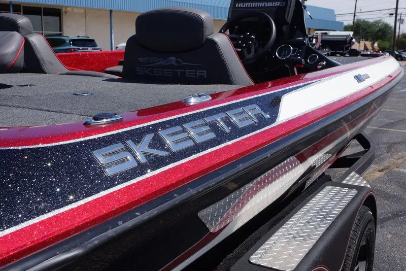 Slide: The Image of 2019 Skeeter ZX250 boat with sparkling red and white finish, featuring sleek design details. - 14