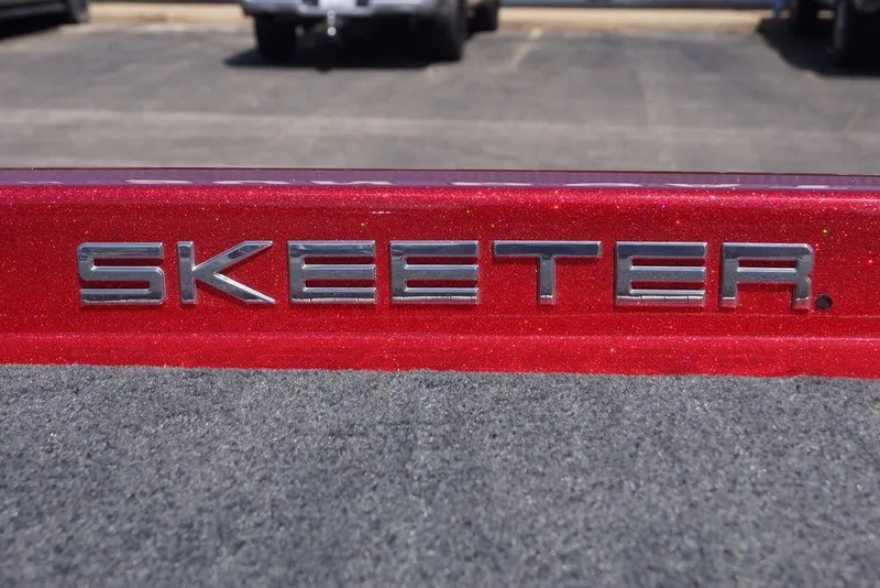 Slide: The Image of Red Skeeter ZX250 boat emblem, 2019 model, on a textured surface. - 18