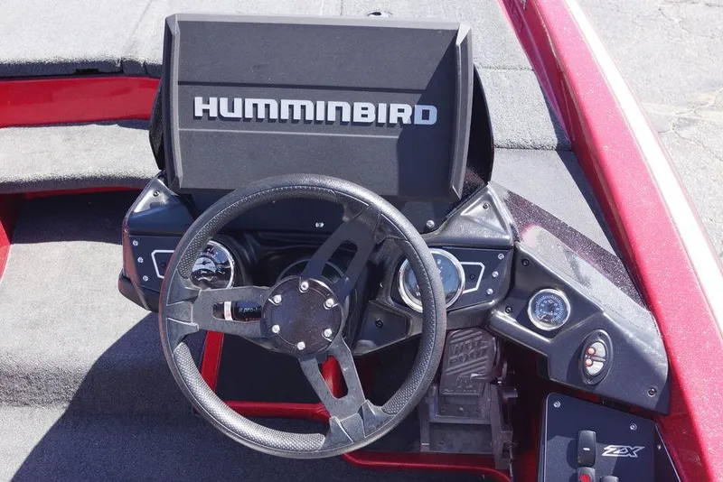 Slide: The Image of 2019 Skeeter ZX250 boat dashboard with Humminbird display and steering wheel. - 2