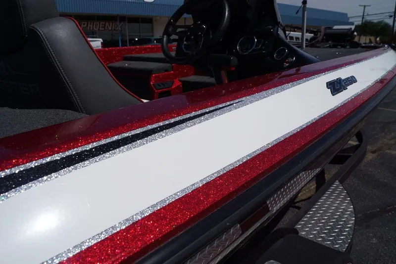 Slide: The Image of 2019 Skeeter ZX250 boat with red and white glitter finish, close-up view. - 25
