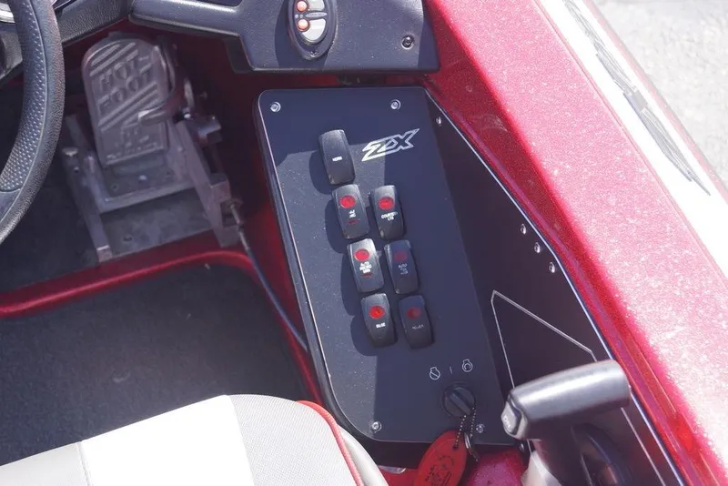 Slide: The Image of Control panel of a 2019 Skeeter ZX250 boat with switches and steering wheel. - 6
