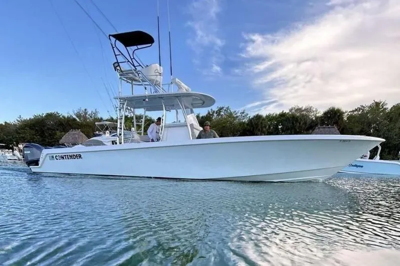 The Image of 2024 Contender 39 ST boat on calm water, clear sky background. - 0