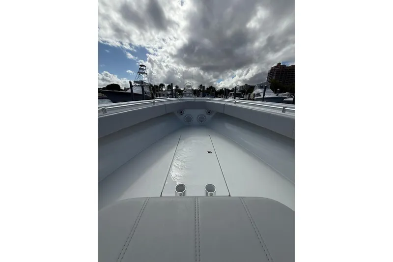 Slide: The Image of 2024 Contender 39 ST boat interior with cloudy sky and marina view. - 14