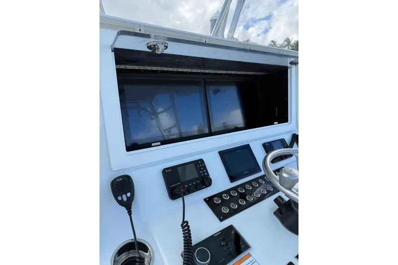 Slide: The Image of 2024 Contender 39 ST boat dashboard with modern controls and navigation screens. - 18