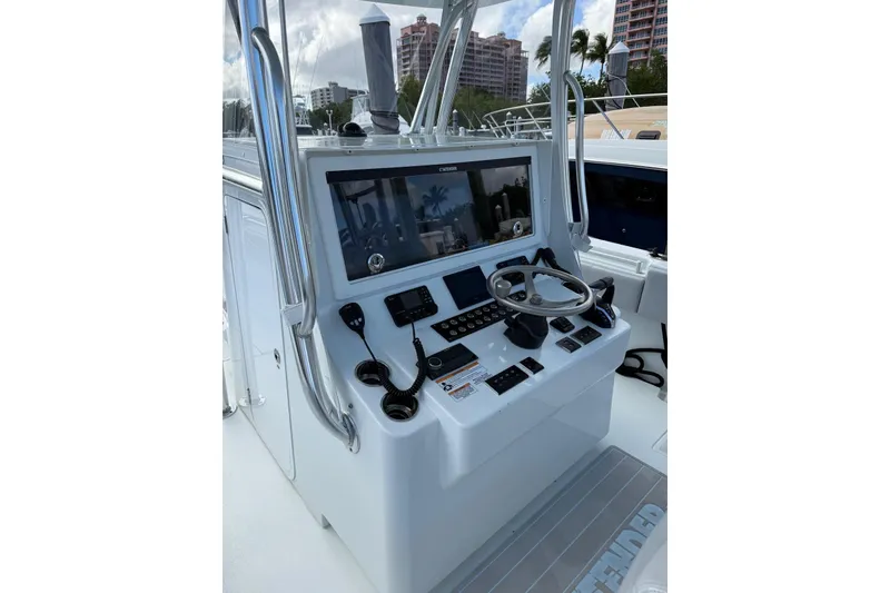 Slide: The Image of 2024 Contender 39 ST boat console with steering wheel and navigation controls. - 19