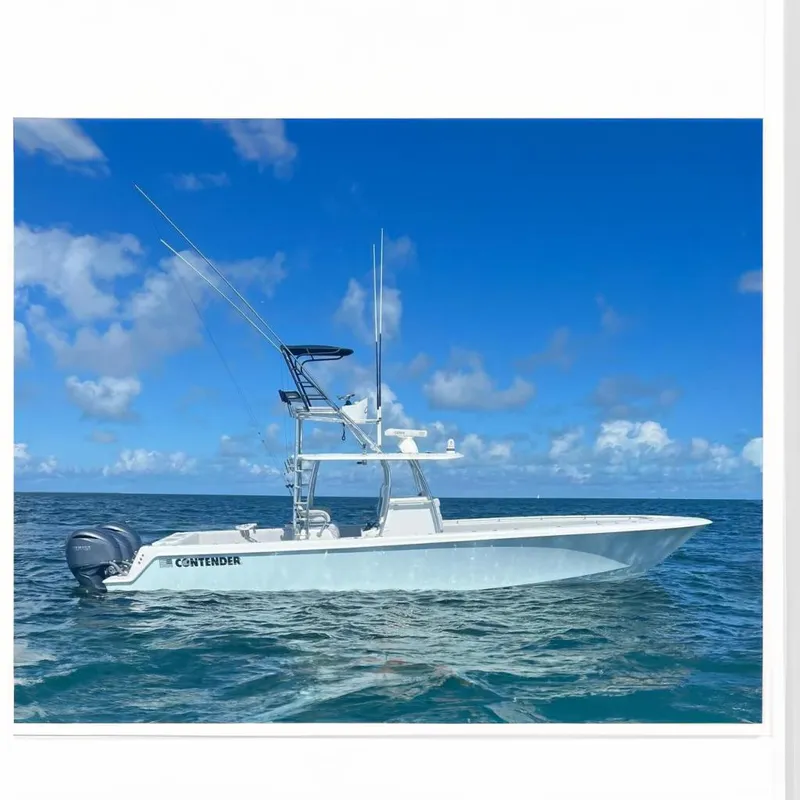 Slide: The Image of 2024 Contender 39 ST boat on open water under a partly cloudy sky. - 2