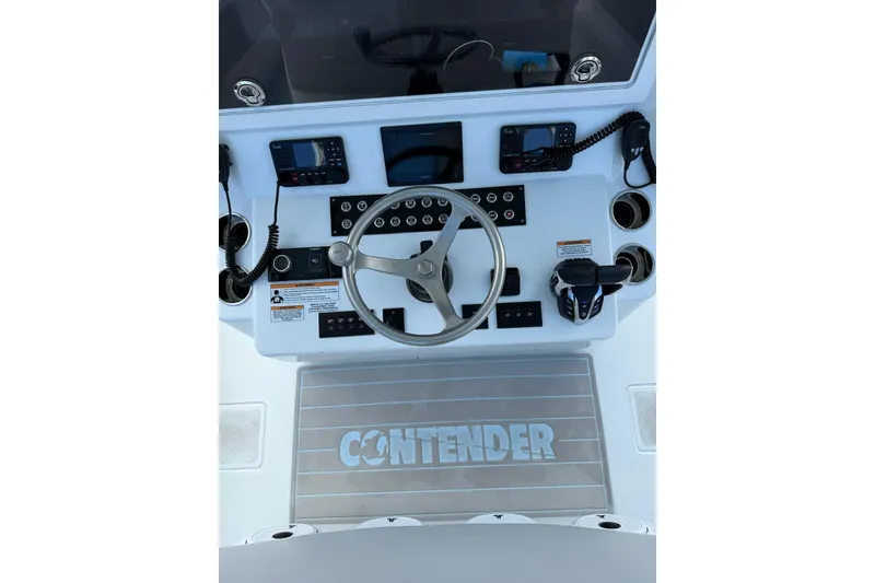 Slide: The Image of 2024 Contender 39 ST boat dashboard with steering wheel and navigation controls. - 20