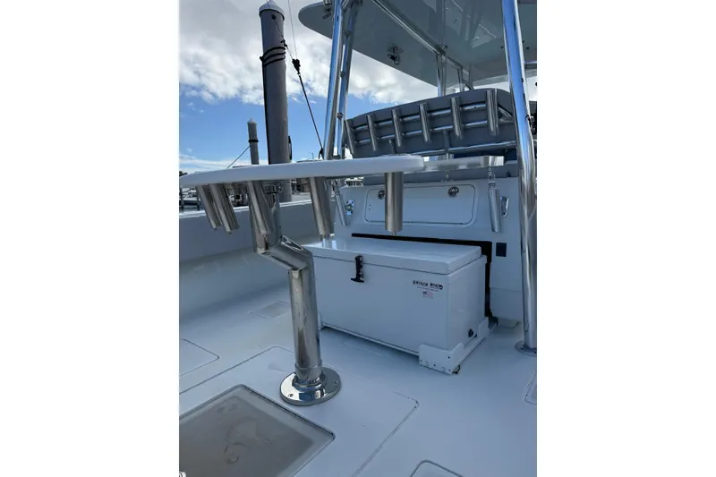 Slide: The Image of 2024 Contender 39 ST boat deck with rod holders and storage compartment. - 23