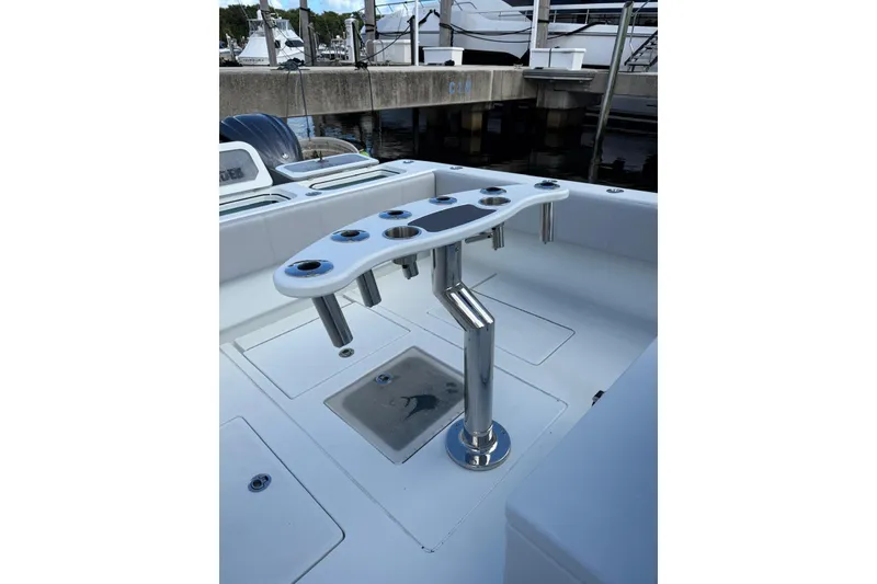 Slide: The Image of 2024 Contender 39 ST boat interior with rod holders and seating at marina. - 24