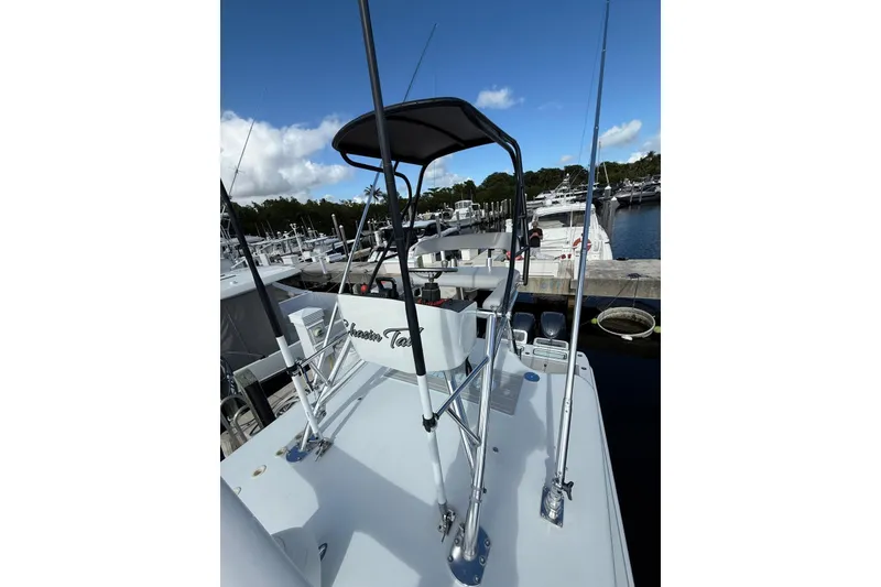 Slide: The Image of 2024 Contender 39 ST boat docked at marina under clear blue sky. - 29