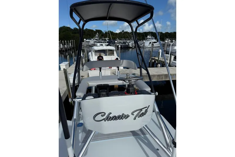 Slide: The Image of 2024 Contender 39 ST boat docked at marina, featuring sleek design and modern controls. - 31