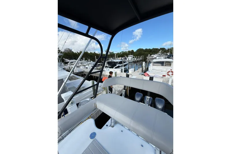 Slide: The Image of 2024 Contender 39 ST boat docked at marina with clear blue sky. - 34