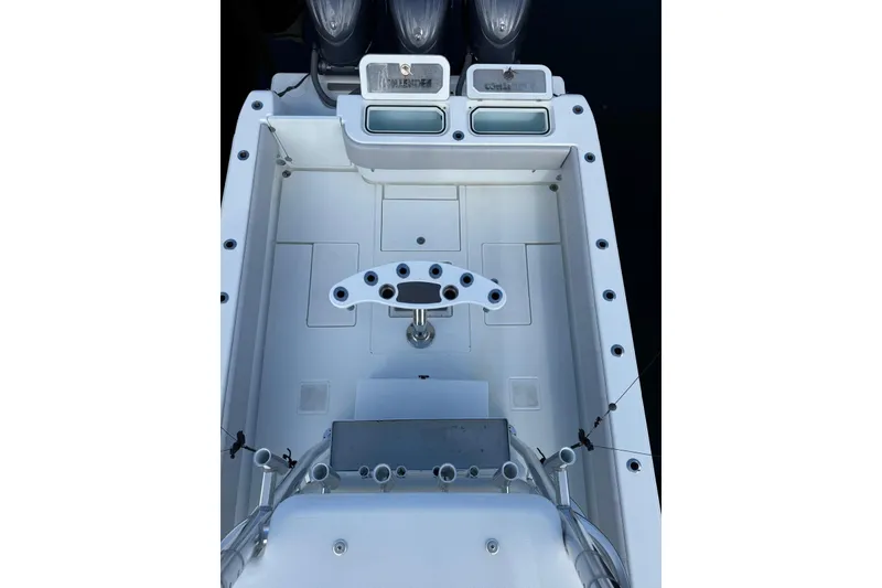 Slide: The Image of 2024 Contender 39 ST boat deck with fishing rod holders and storage compartments. - 35