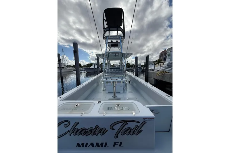 Slide: The Image of 2024 Contender 39 ST boat docked in Miami, FL, under cloudy sky. - 36