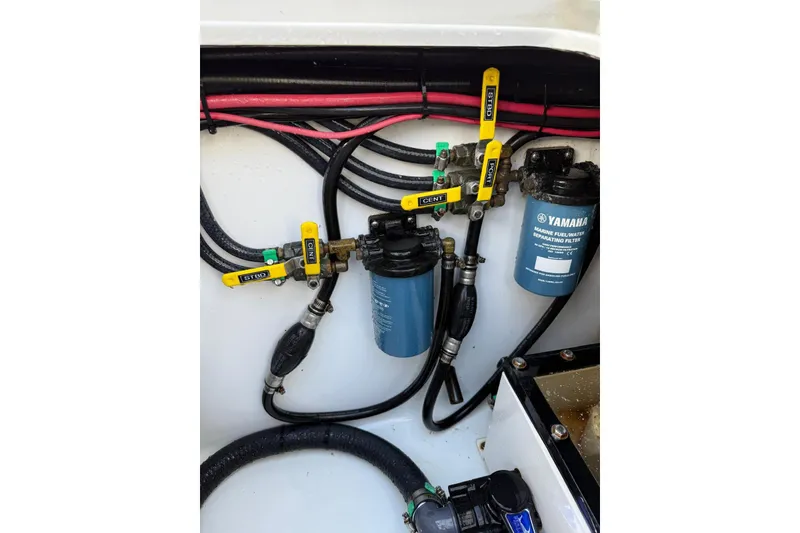 Slide: The Image of 2024 Contender 39 ST boat engine compartment with Yamaha marine fuel filters and valves. - 40