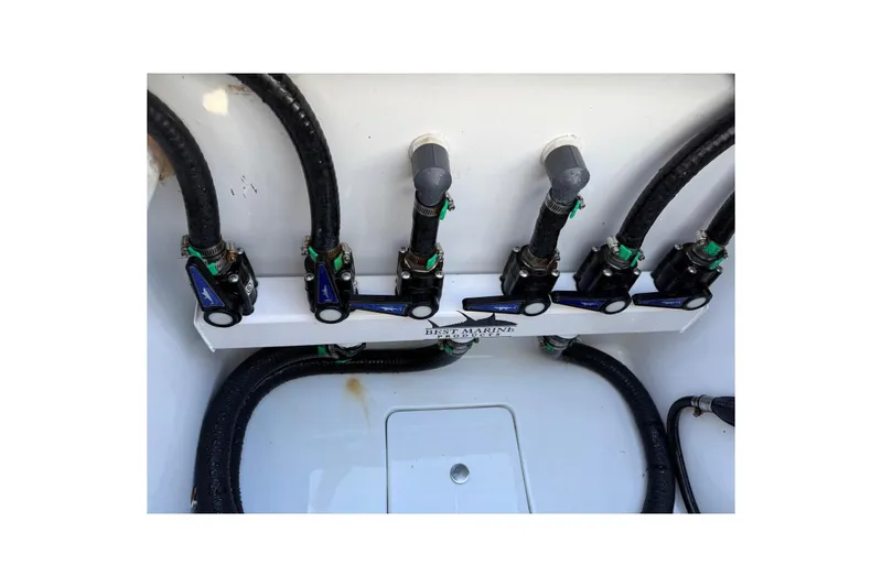 Slide: The Image of 2024 Contender 39 ST boat plumbing system with multiple valves and hoses. - 41