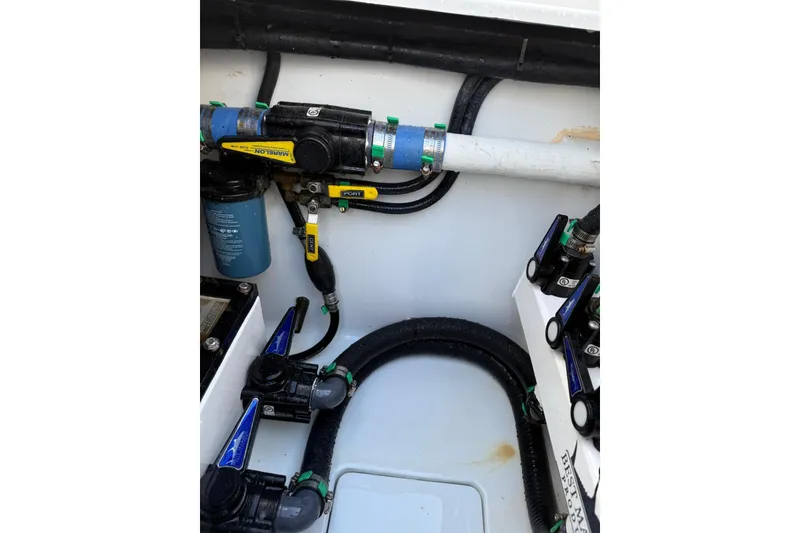 Slide: The Image of 2024 Contender 39 ST boat plumbing system with hoses and valves. - 42