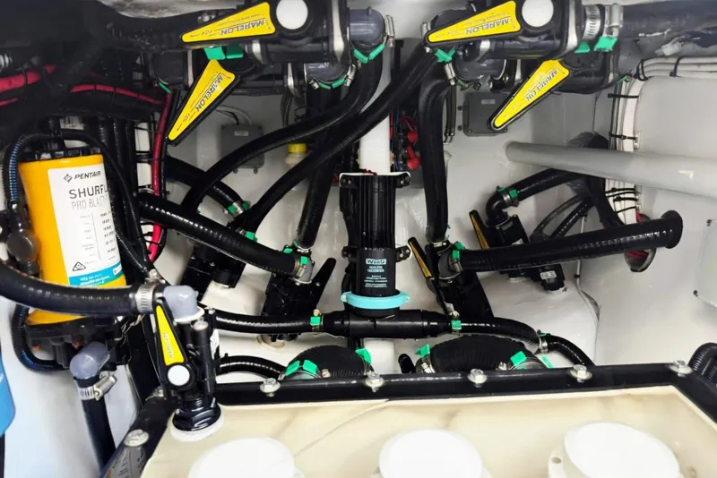 Slide: The Image of Engine compartment of a 2024 Contender 39 ST boat, showcasing complex wiring and components. - 43