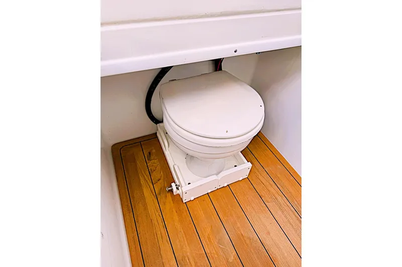 Slide: The Image of 2024 Contender 39 ST boat toilet on wooden flooring. - 44