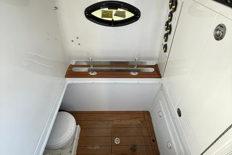 Slide: The Image of 2024 Contender 39 ST boat interior with wooden flooring and compact toilet. - 45