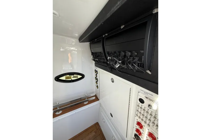 Slide: The Image of 2024 Contender 39 ST boat interior with control panel and porthole window. - 46