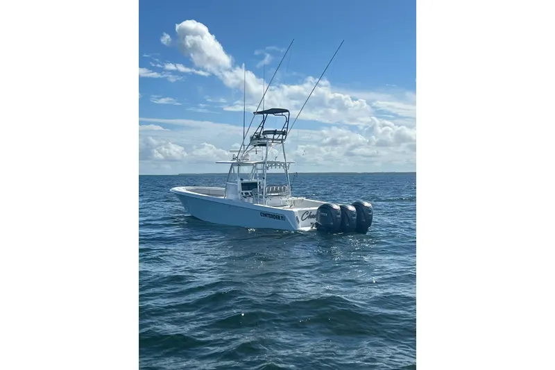 Slide: The Image of 2024 Contender 39 ST boat on open water under blue sky. - 5