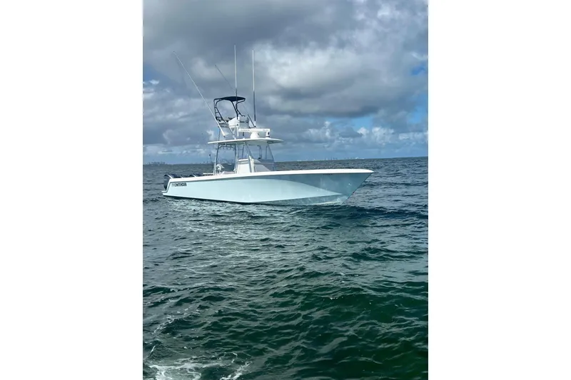Slide: The Image of 2024 Contender 39 ST boat on open ocean under cloudy sky. - 6