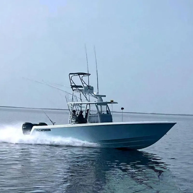 Slide: The Image of 2024 Contender 39 ST boat at sea during sunset, with fishing rods. - 8