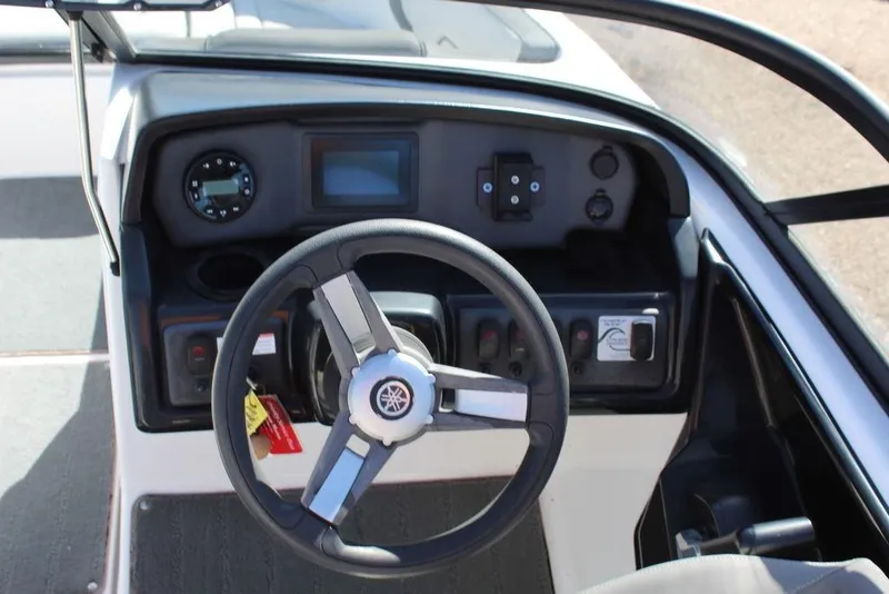 Slide: The Image of 2019 Skeeter SX190 boat dashboard with steering wheel and control panel. - 14