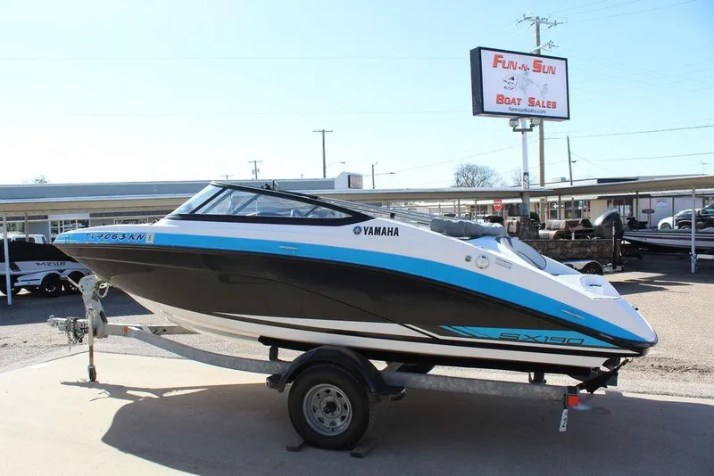 Slide: The Image of 2019 Skeeter SX190 boat on trailer at dealership, featuring Yamaha branding. - 15