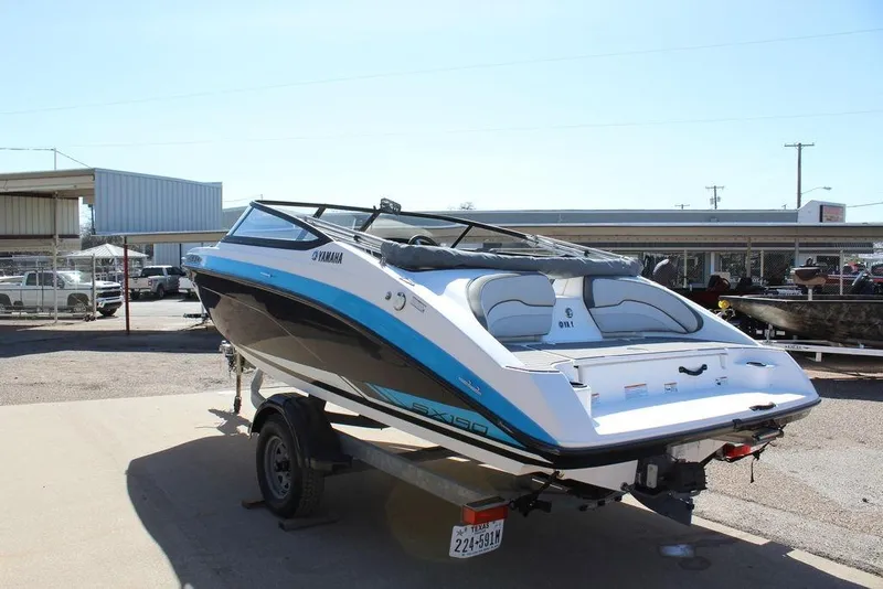 Slide: The Image of 2019 Skeeter SX190 boat on trailer, parked outdoors, showcasing sleek design and Yamaha branding. - 4