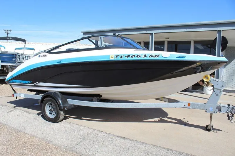 Slide: The Image of 2019 Skeeter SX190 boat on trailer, black and white design, parked outdoors. - 7