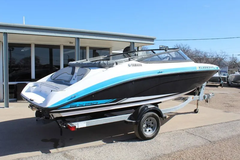 Slide: The Image of 2019 Skeeter SX190 boat on trailer, parked outside a building. - 9