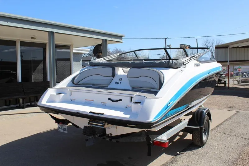 Slide: The Image of 2019 Skeeter SX190 boat on trailer, parked outside a building. - 1