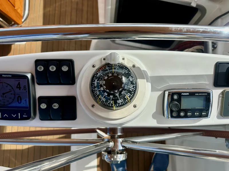 Slide: The Image of Jeanneau 57 yacht helm with compass, navigation instruments, and control panel, 2014 model. - 33