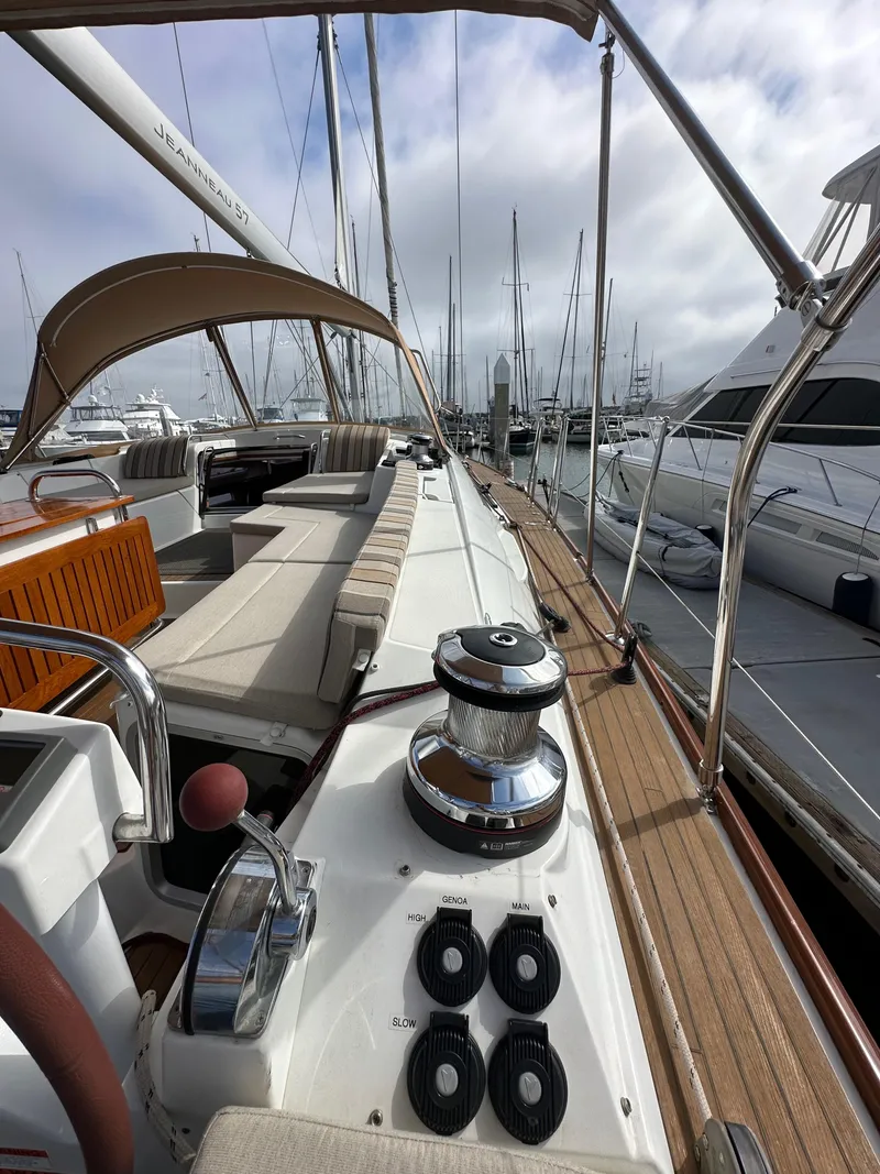 Slide: The Image of 2014 Jeanneau 57 yacht deck with seating and winch, docked at marina. - 37